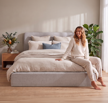 The Naptime Mellow upholstered bed frame made up in a bright bedroom
