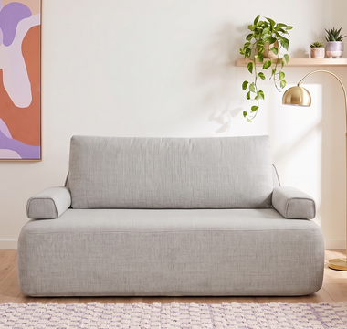 The Naptime Stay sofa bed in sofa mode in a bright living room