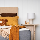 Close up of Naptime dual mattress with pillows and throws