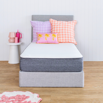 Naptime dual mattress and bed base with pillows and a rug