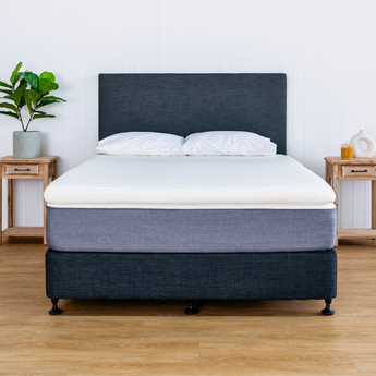 topper on a mattress with pillows bed base and headboard