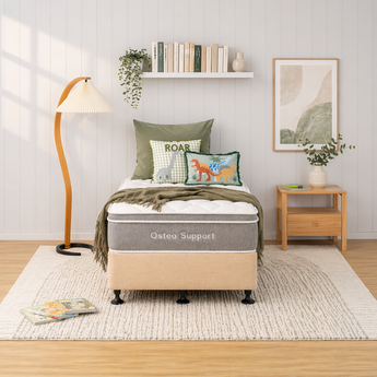 Bedroom with a bed labeled 'Osteo Support' and decorative pillows and bed base