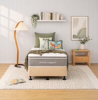 Bedroom with a bed labeled 'Osteo Support' and decorative pillows and bed base