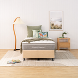 Natural bed with 'Osteo Support' mattress in a bedroom setting with pillows and decor.