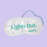 Sleep mask with 'Lights Out' text on a light gray background
