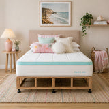 Bedroom with a bed featuring an Oasis Gel mattress and Scandi bed base, decorative pillows, and a beach-themed wall art.