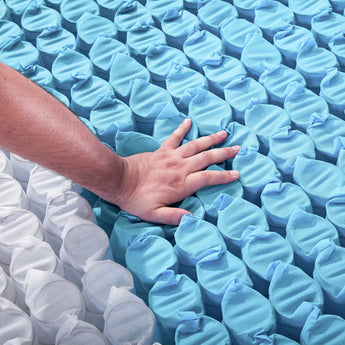 Hand on pocket springs pushing down