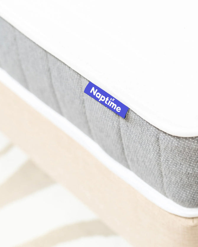 Gray mattress with 'Naptime' logo on a white background