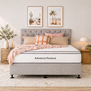 Bed with 'Advance Posture' mattress in a bedroom setting with decor elements.