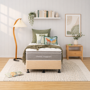Bedroom with a bed labeled 'Osteo Support' and decorative pillows and bed base 