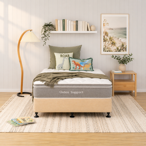 Bedroom with a bed featuring an Osteo Support mattress, bed base, decorative pillows, and a nightstand.