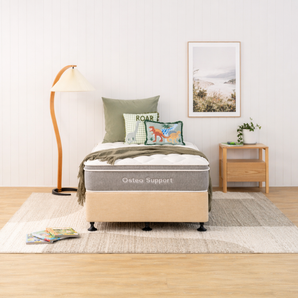 Natural bed with 'Osteo Support' mattress in a bedroom setting with pillows and decor.