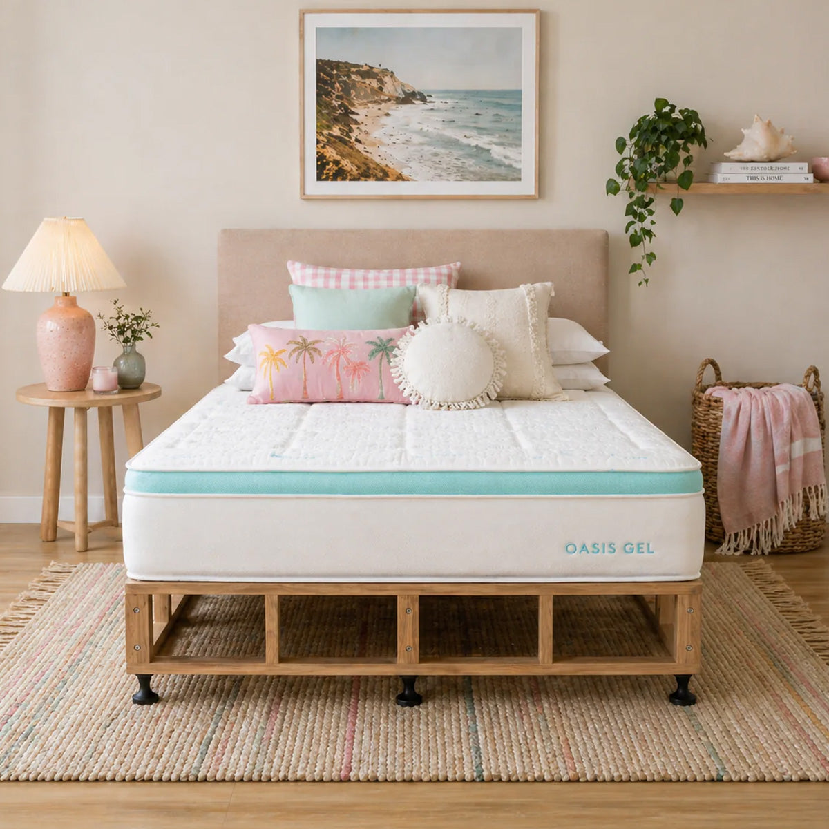 Bedroom with a bed featuring an Oasis Gel mattress and Scandi bed base, decorative pillows, and a beach-themed wall art.