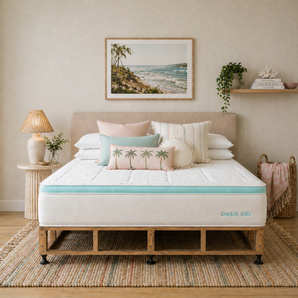 Bedroom with a bed featuring a mattress labeled 'Oasis Gel' and decorative pillows.