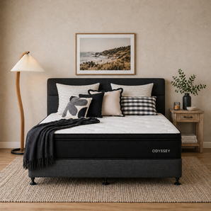 Bedroom with Odyssey mattress, pillows, and decor