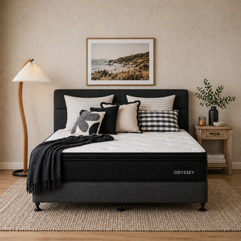 Bedroom with Odyssey mattress, pillows, and decor