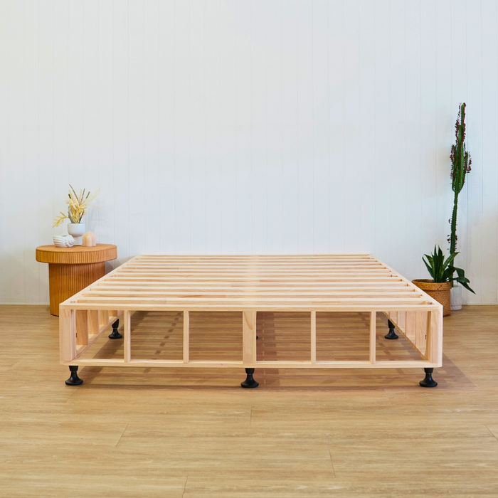 Timber bed base with side table and a pot plant with white background 