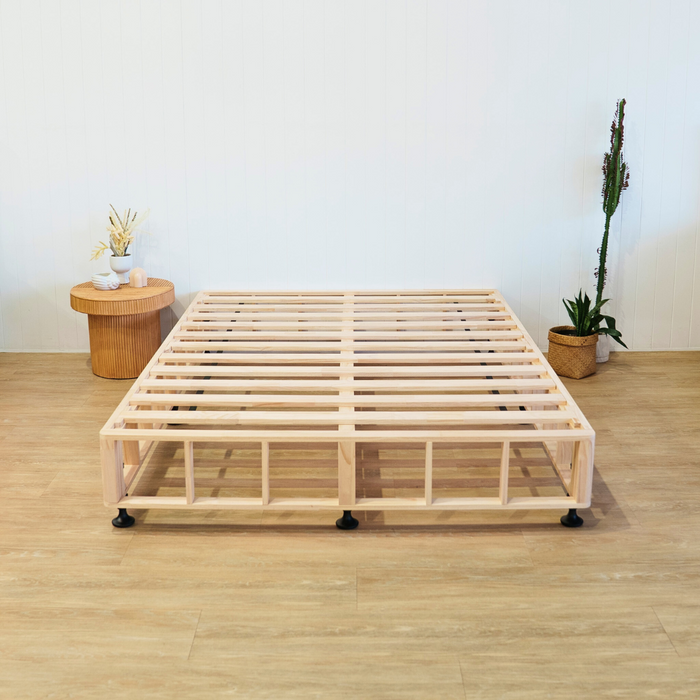 Timber bed base with side table and  pot plant 
