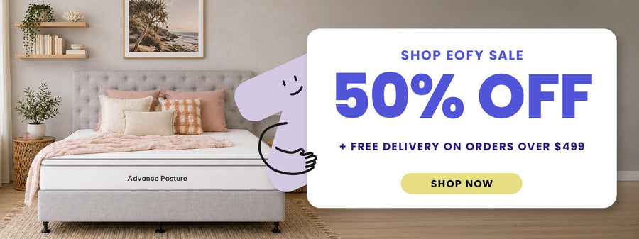 Advertisement for a mattress sale with a 50% off offer in a bedroom setting.